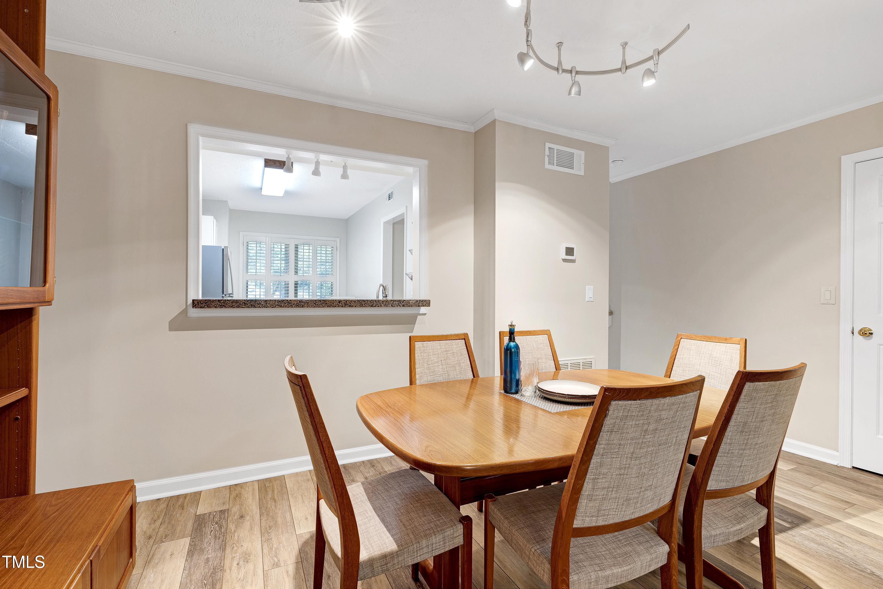 202 Oak Hollow Court Raleigh, NC 27613 - Photo 14 of 44 a view of a dining room with furniture and wooden floor