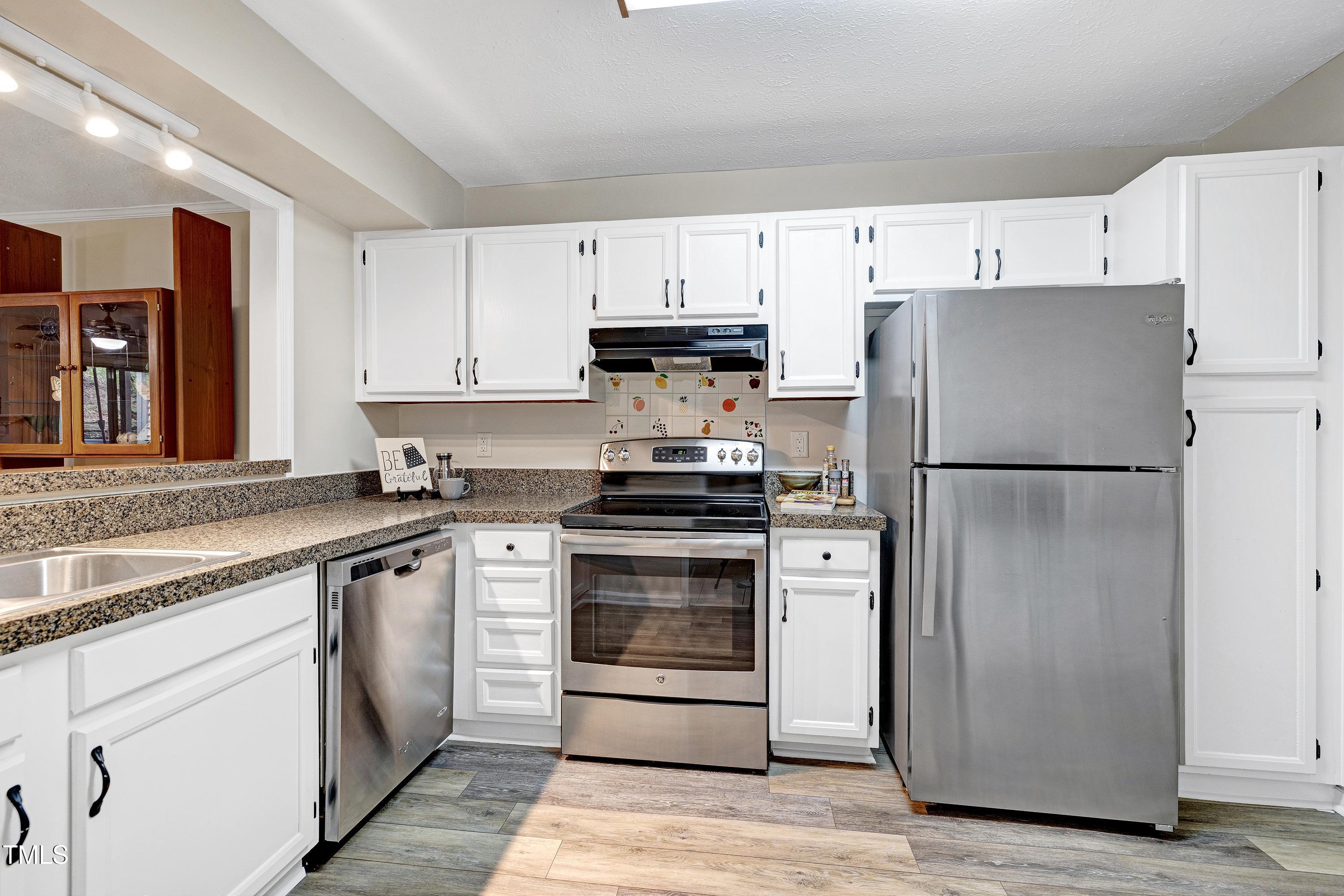 202 Oak Hollow Court Raleigh, NC 27613 - Photo 15 of 44 a kitchen with cabinets stainless steel appliances and a counter space