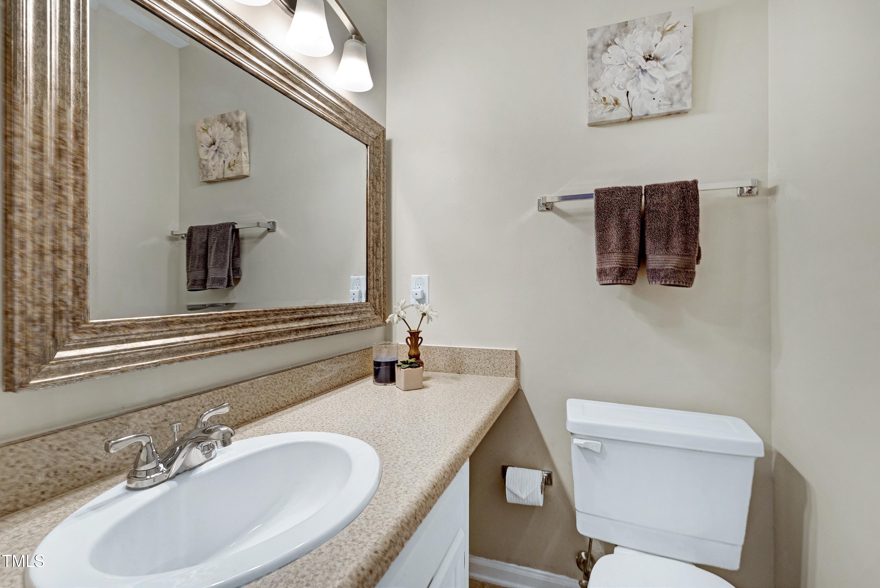 202 Oak Hollow Court Raleigh, NC 27613 - Photo 18 of 44 a bathroom with a granite countertop sink and a mirror