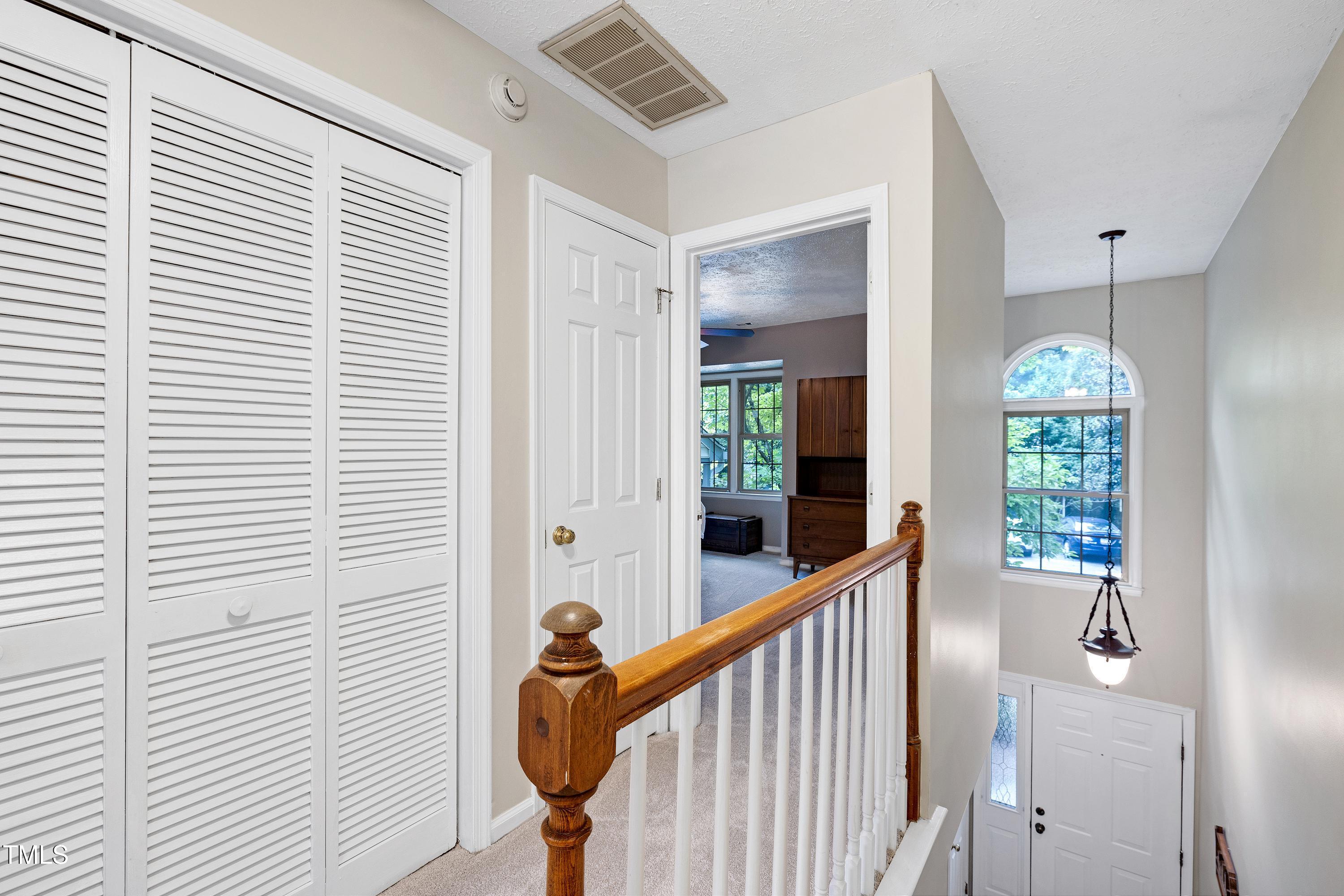 202 Oak Hollow Court Raleigh, NC 27613 - Photo 19 of 44 a view of a hallway with windows and stairs