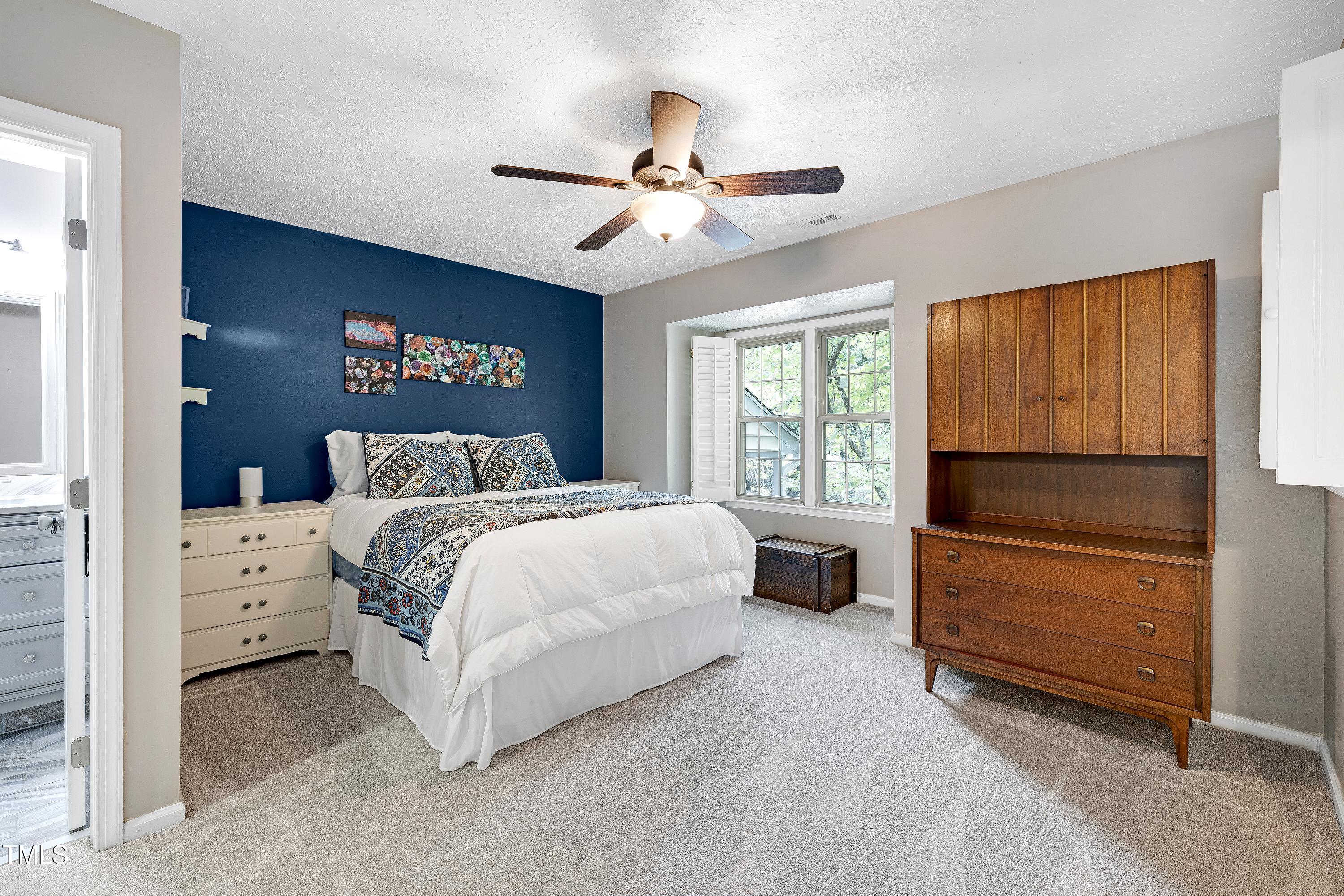 202 Oak Hollow Court Raleigh, NC 27613 - Photo 20 of 44 a bedroom with a bed and a window