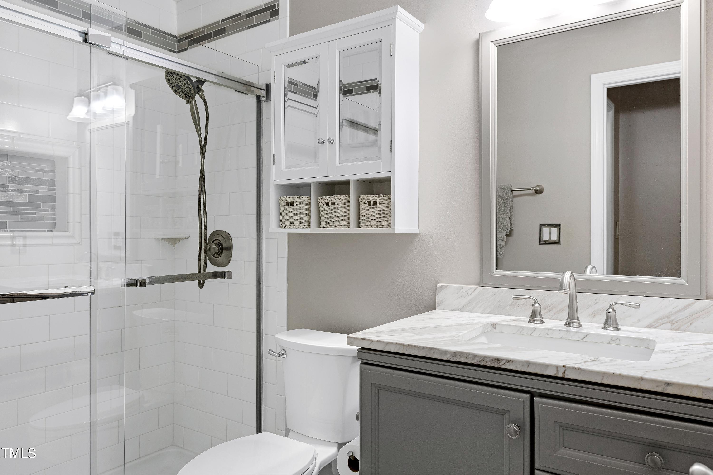 202 Oak Hollow Court Raleigh, NC 27613 - Photo 22 of 44 a bathroom with a granite countertop sink toilet and shower