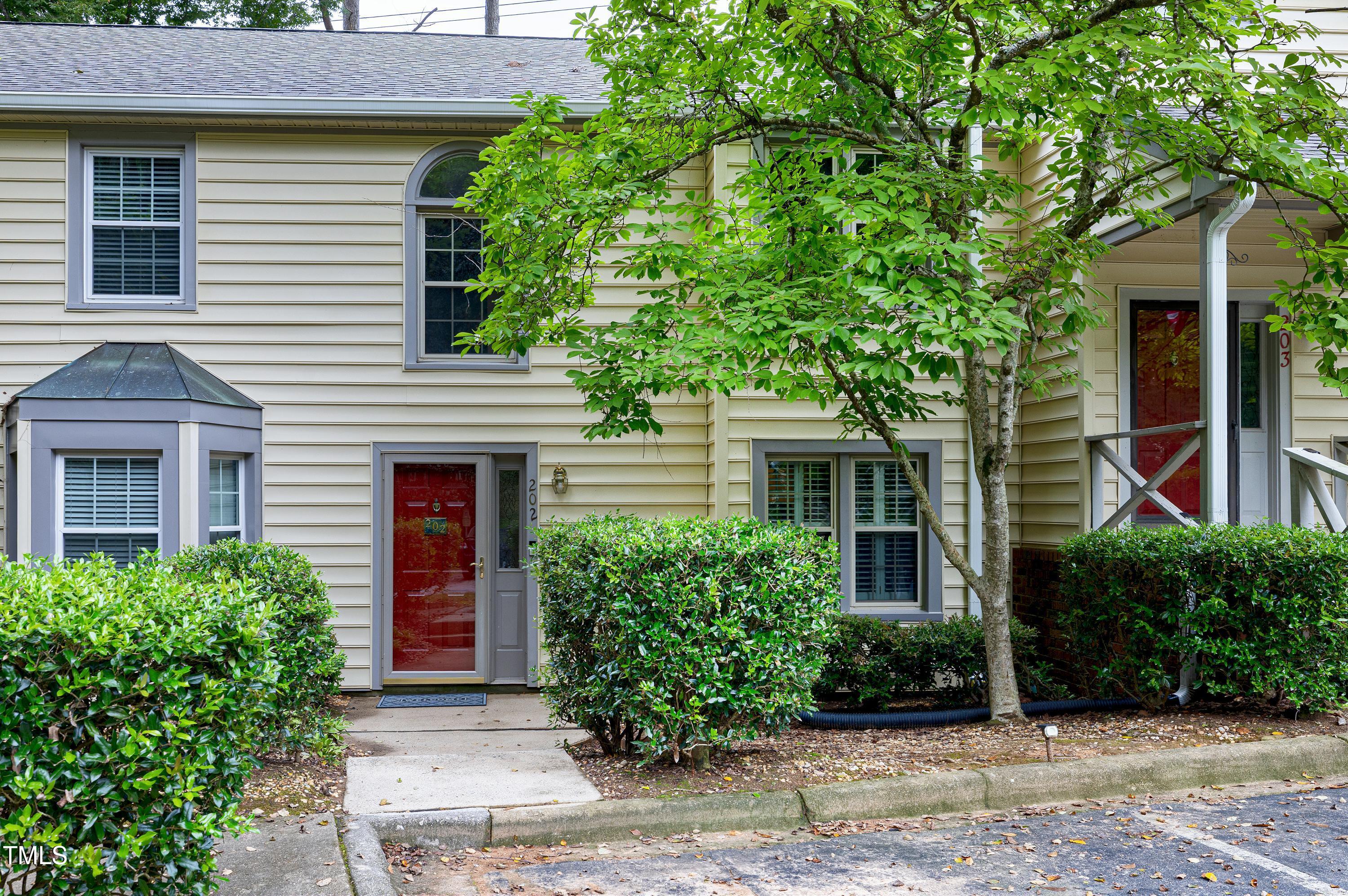 202 Oak Hollow Court Raleigh, NC 27613 - Photo 2 of 44 a front view of a house with garden