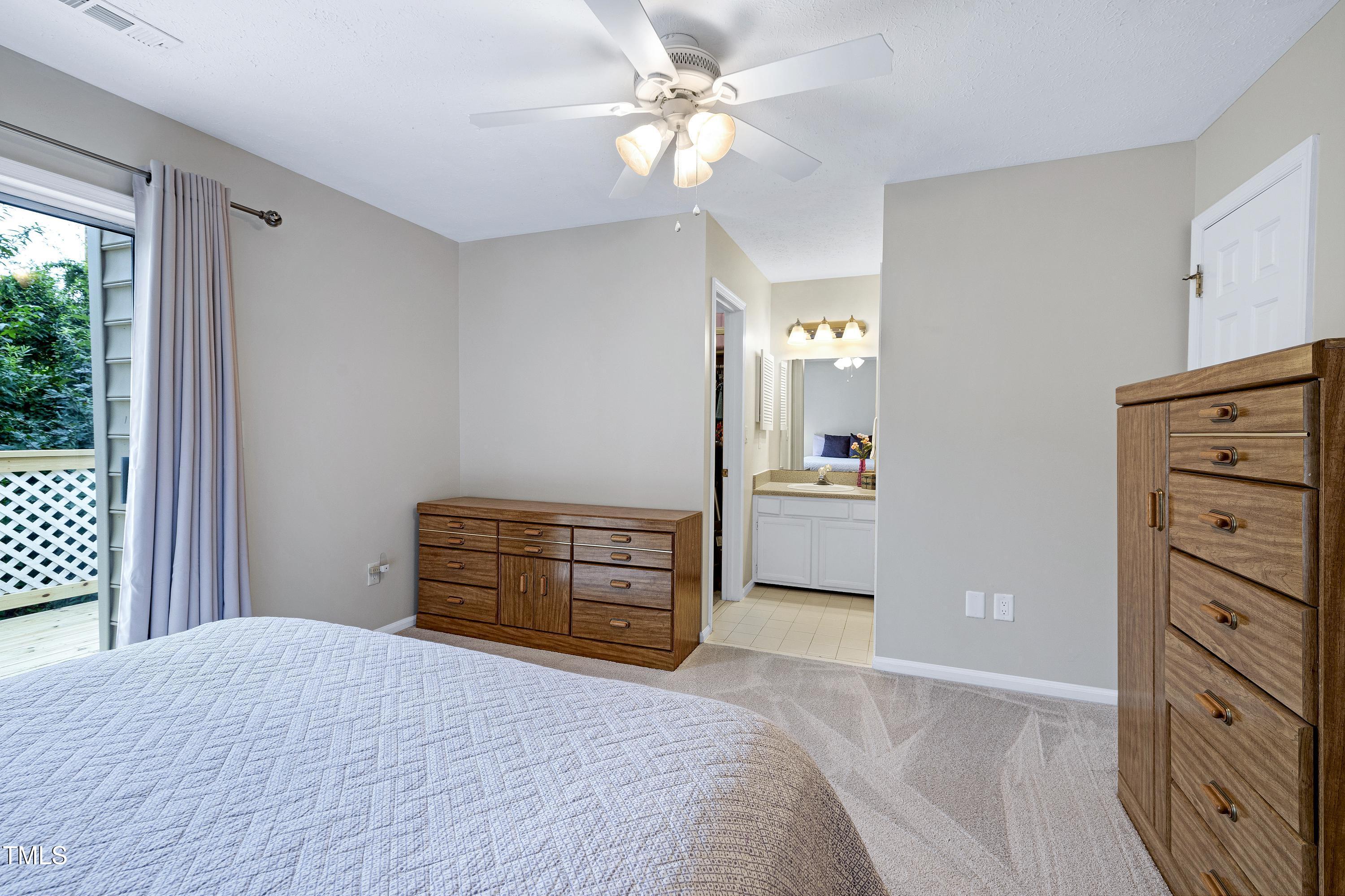 202 Oak Hollow Court Raleigh, NC 27613 - Photo 30 of 44 a bedroom with a bed and a dresser