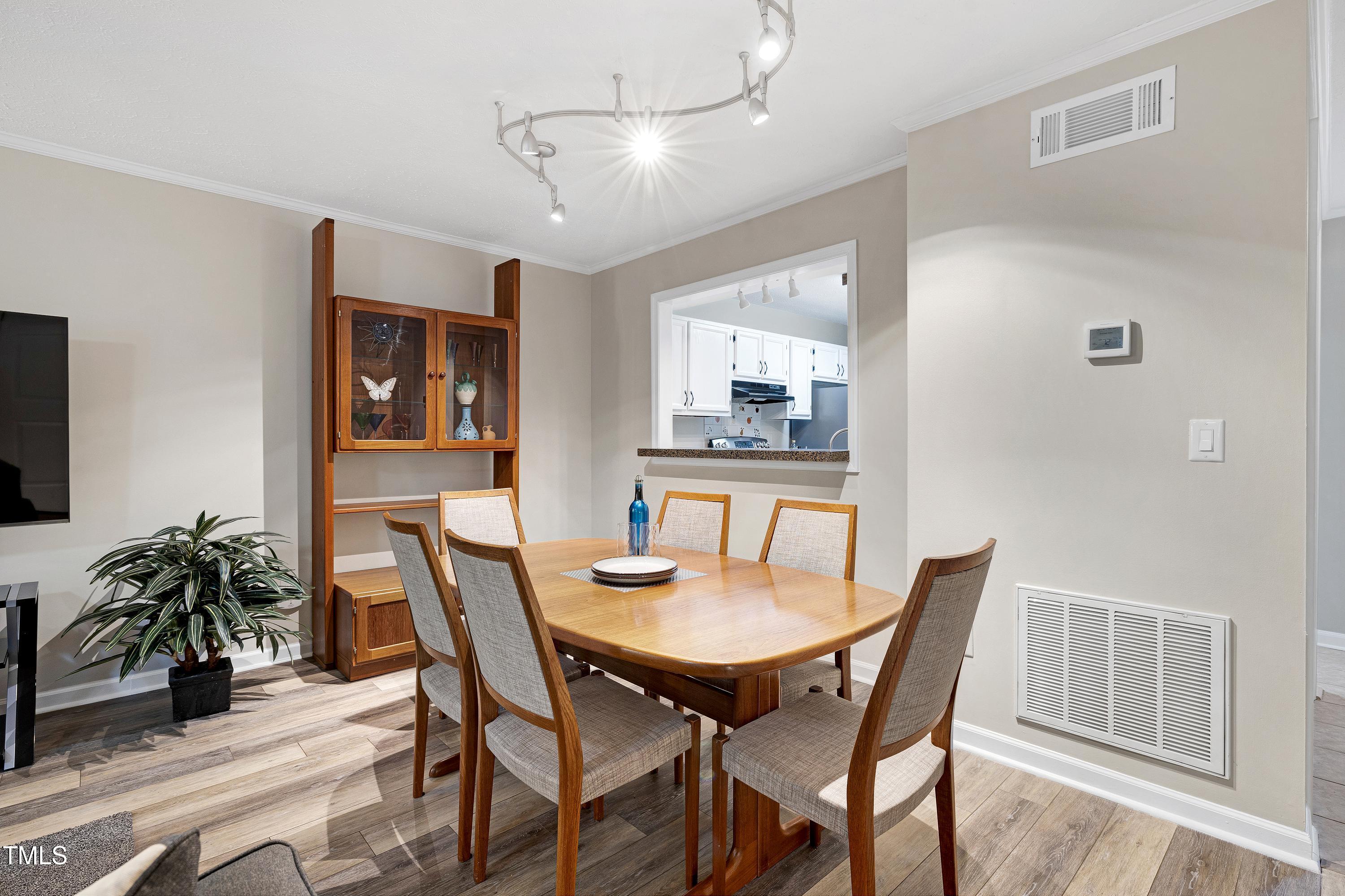 202 Oak Hollow Court Raleigh, NC 27613 - Photo 5 of 44 a view of a dining room with furniture and wooden floor