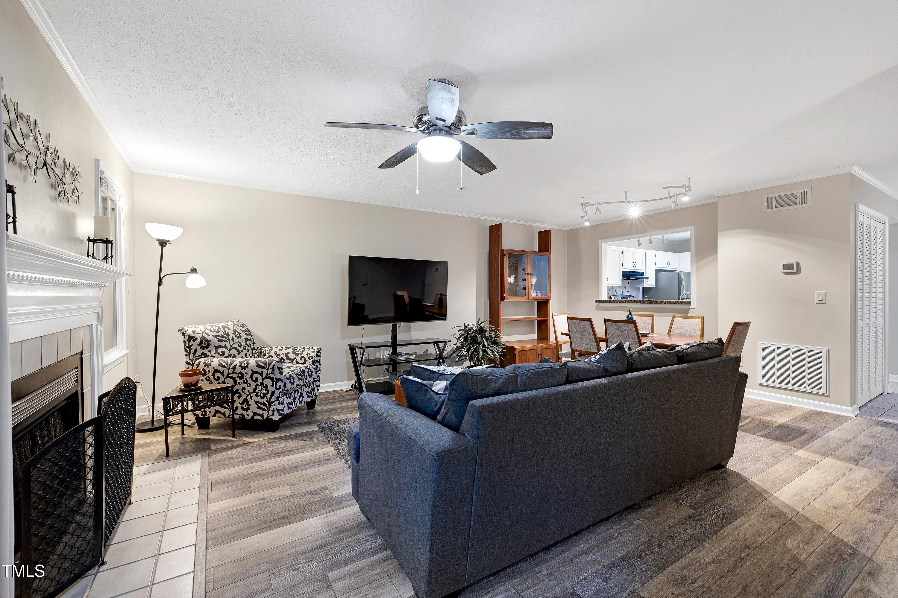 202 Oak Hollow Court Raleigh, NC 27613 - Photo 8 of 44 a living room with furniture fireplace and flat screen tv
