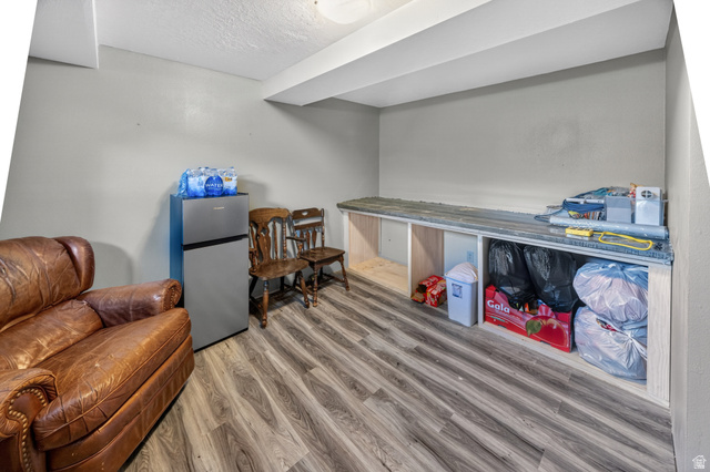 1218 East 100 South Logan, UT 84321 - Photo 18 of 23 Finished space featuring wood-finish flooring, light gray walls, and a recessed ceiling