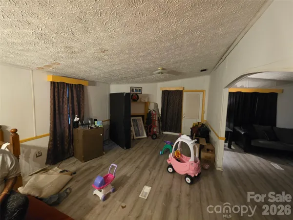 a living room with furniture a flat screen tv and a table