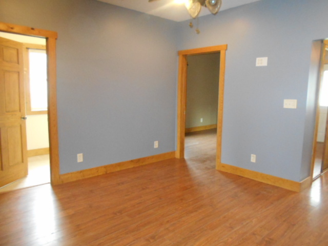 304 South Columbus Street Ransom, IL 60470 - Photo 6 of 24 a view of an empty room with wooden floor and a window