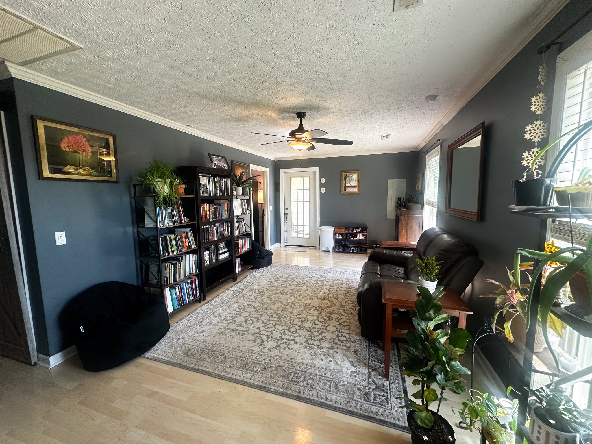 831 Philippi Road Wartrace, TN 37183 - Photo 31 of 51 a living room with lots of furniture and a book shelf