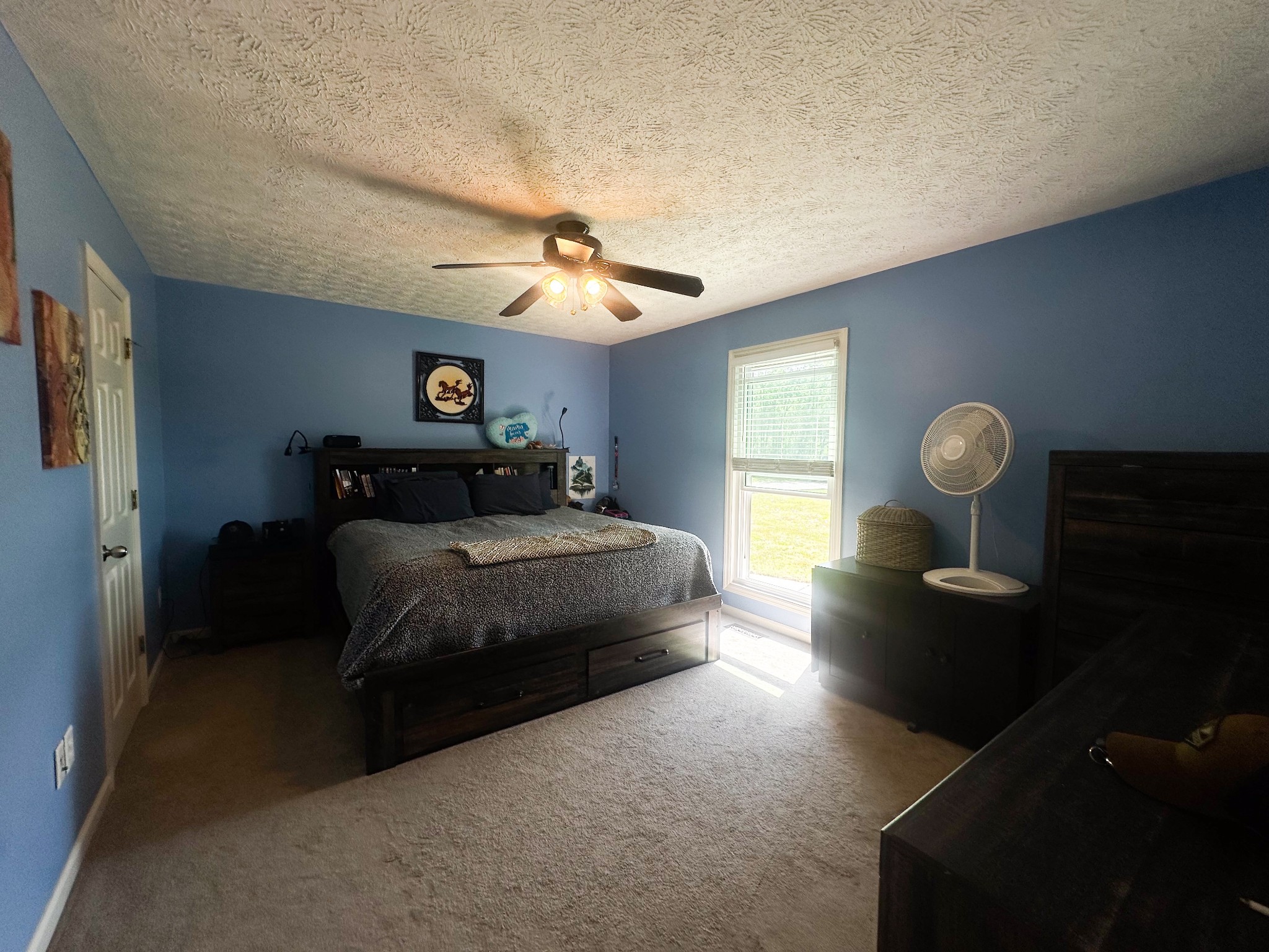 831 Philippi Road Wartrace, TN 37183 - Photo 34 of 51 a spacious bedroom with a bed and a chandelier