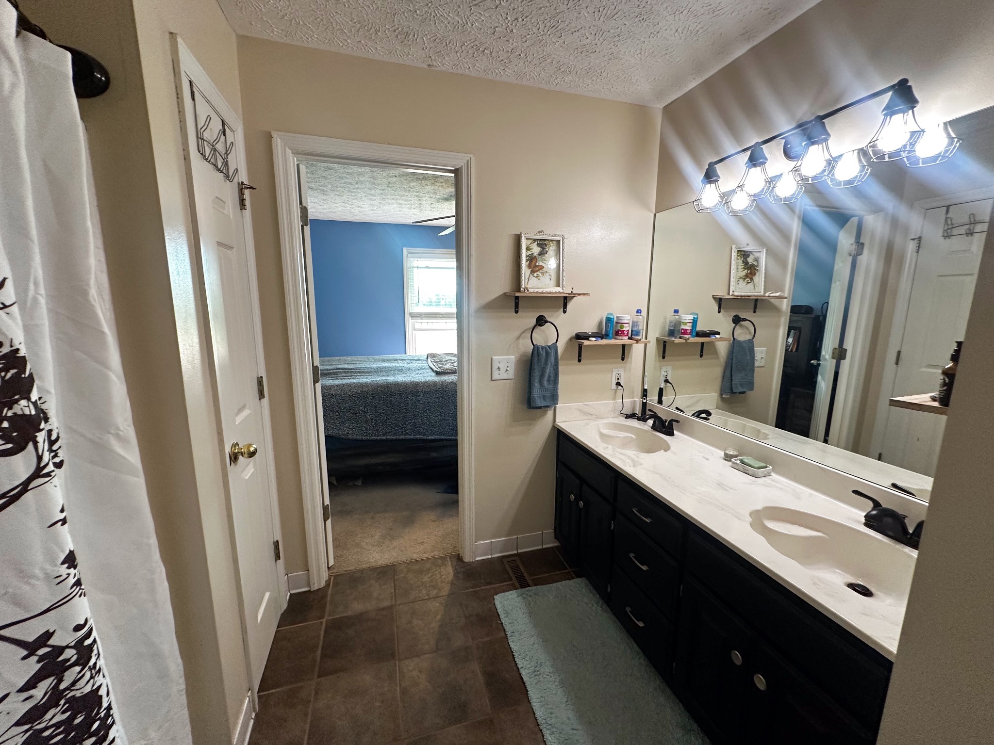 831 Philippi Road Wartrace, TN 37183 - Photo 38 of 51 a bathroom with a double vanity sink a and mirror