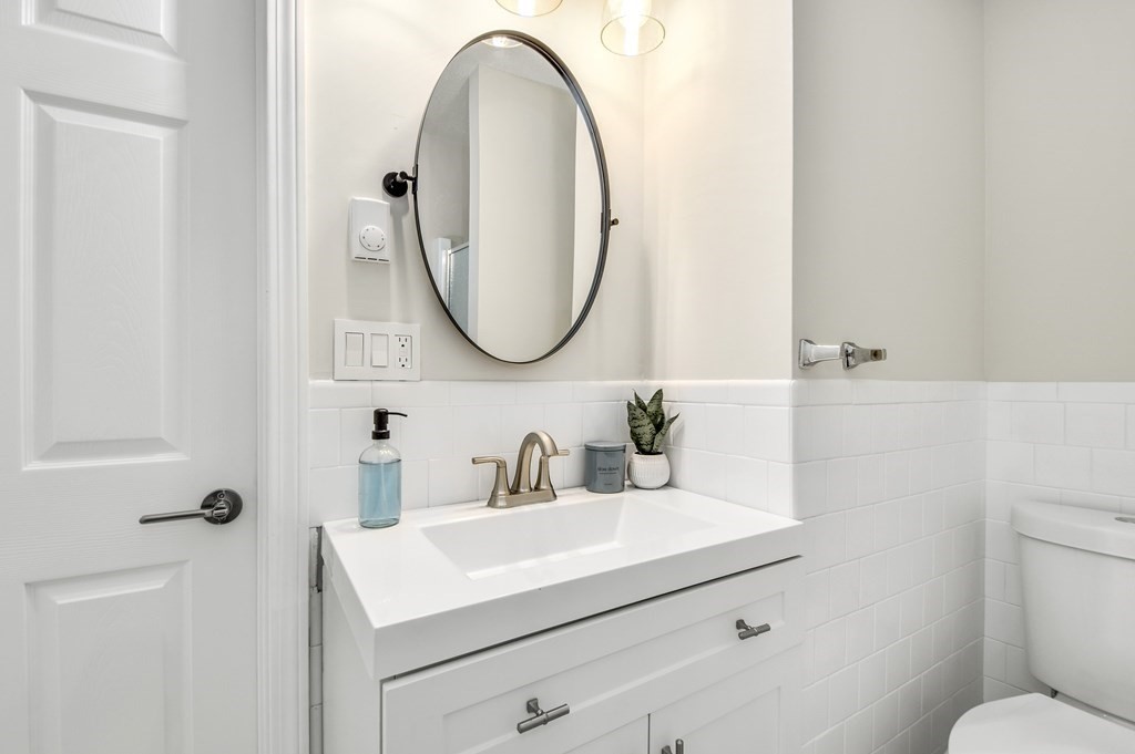 14 Hall Road Webster, MA 01570 - Photo 18 of 26 a bathroom with a sink a toilet and a mirror