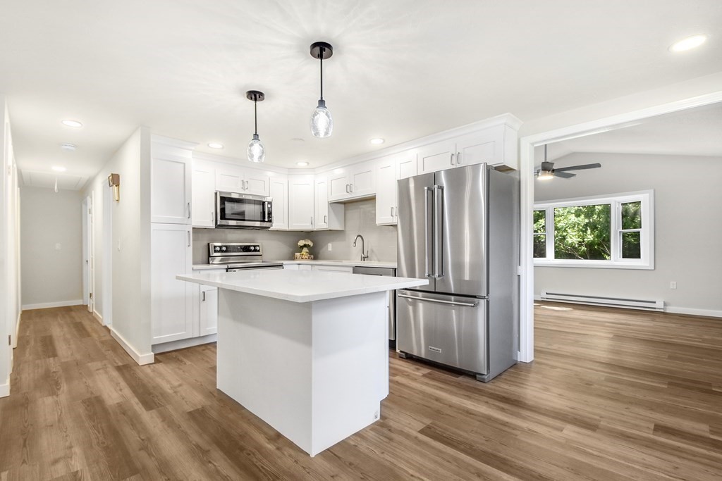 14 Hall Road Webster, MA 01570 - Photo 6 of 26 a kitchen with refrigerator cabinets and wooden floor