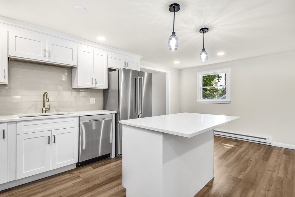 14 Hall Road Webster, MA 01570 - Photo 8 of 26 a kitchen with stainless steel appliances a white refrigerator a sink a stove and white cabinets
