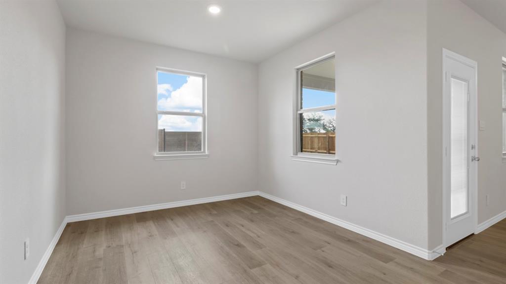 510 Range Road Caddo Mills, TX 75135 - Photo 14 of 25 a view of a room that has wooden floor and windows in it