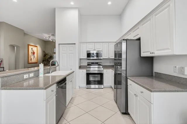 a bedroom with a bed and a lamp on a dresser