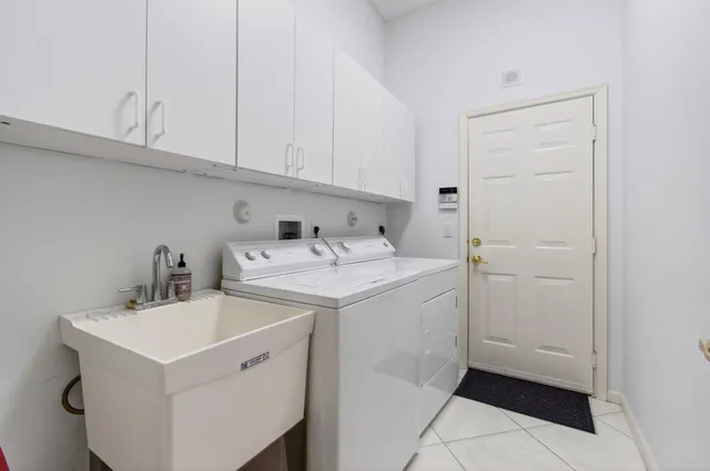 a view of a house with a yard and potted plants