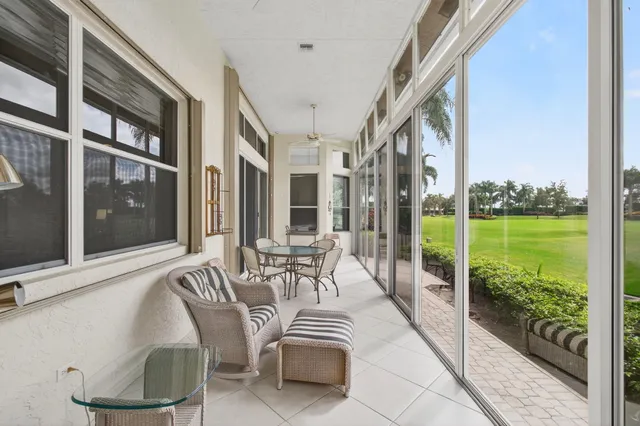 an aerial view of a houses with a yard and lake view