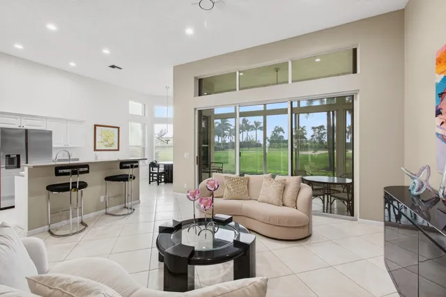 a living room with furniture and painting on the wall