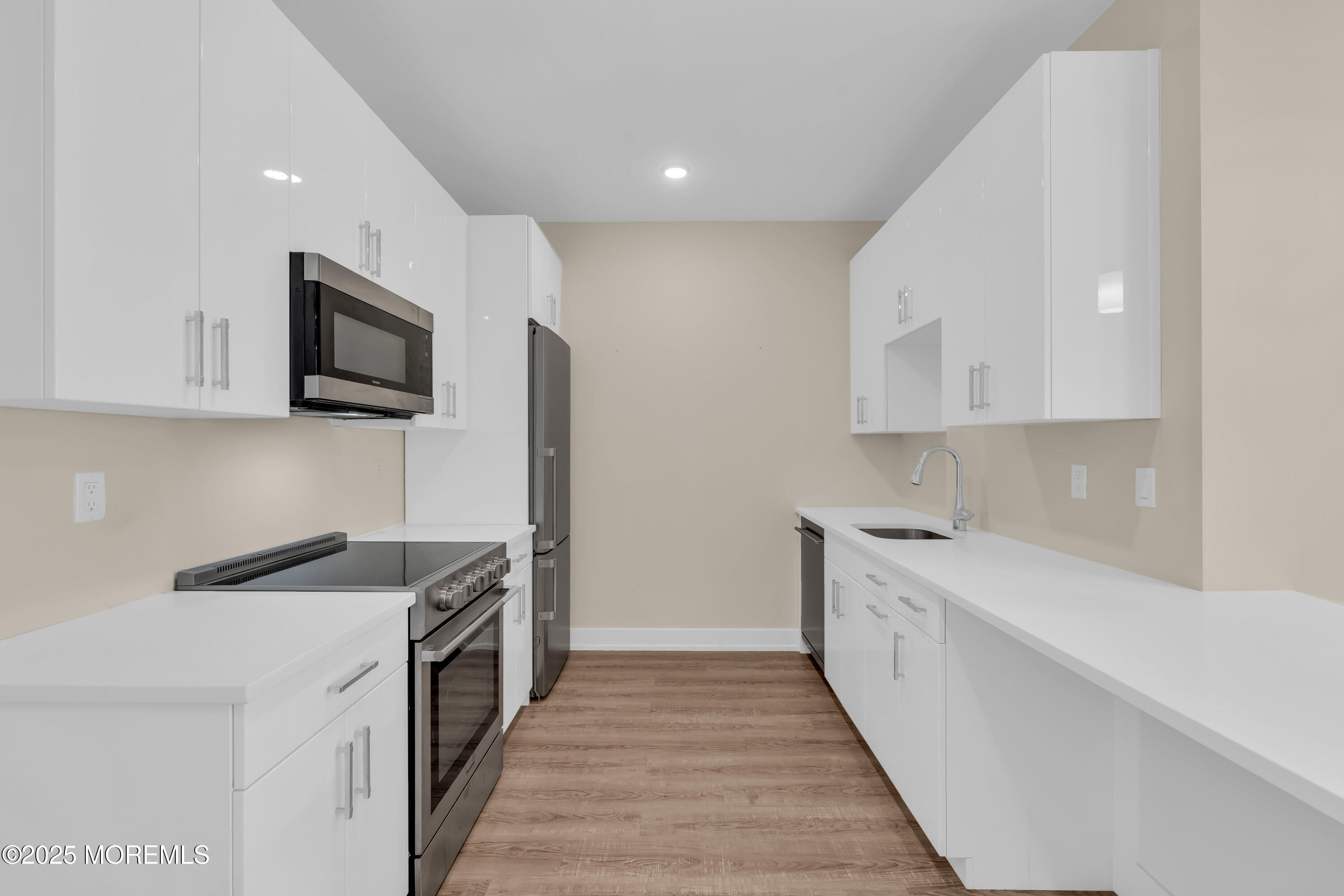 521 Lake Avenue, Unit 408 Asbury Park, NJ 07712 - Photo 12 of 30 a kitchen with a sink and steel appliances