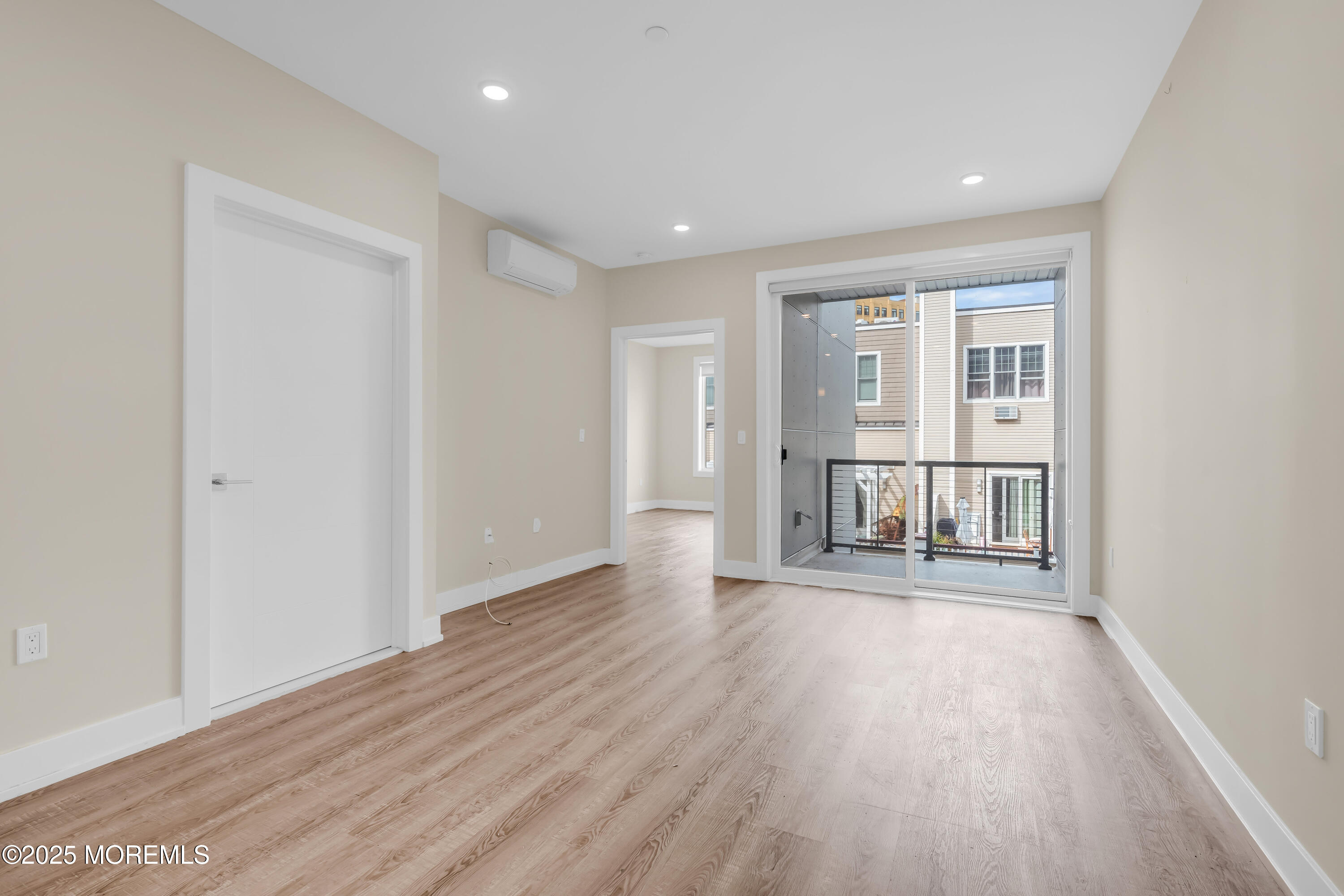 521 Lake Avenue, Unit 408 Asbury Park, NJ 07712 - Photo 16 of 30 wooden floor in an empty room with a window