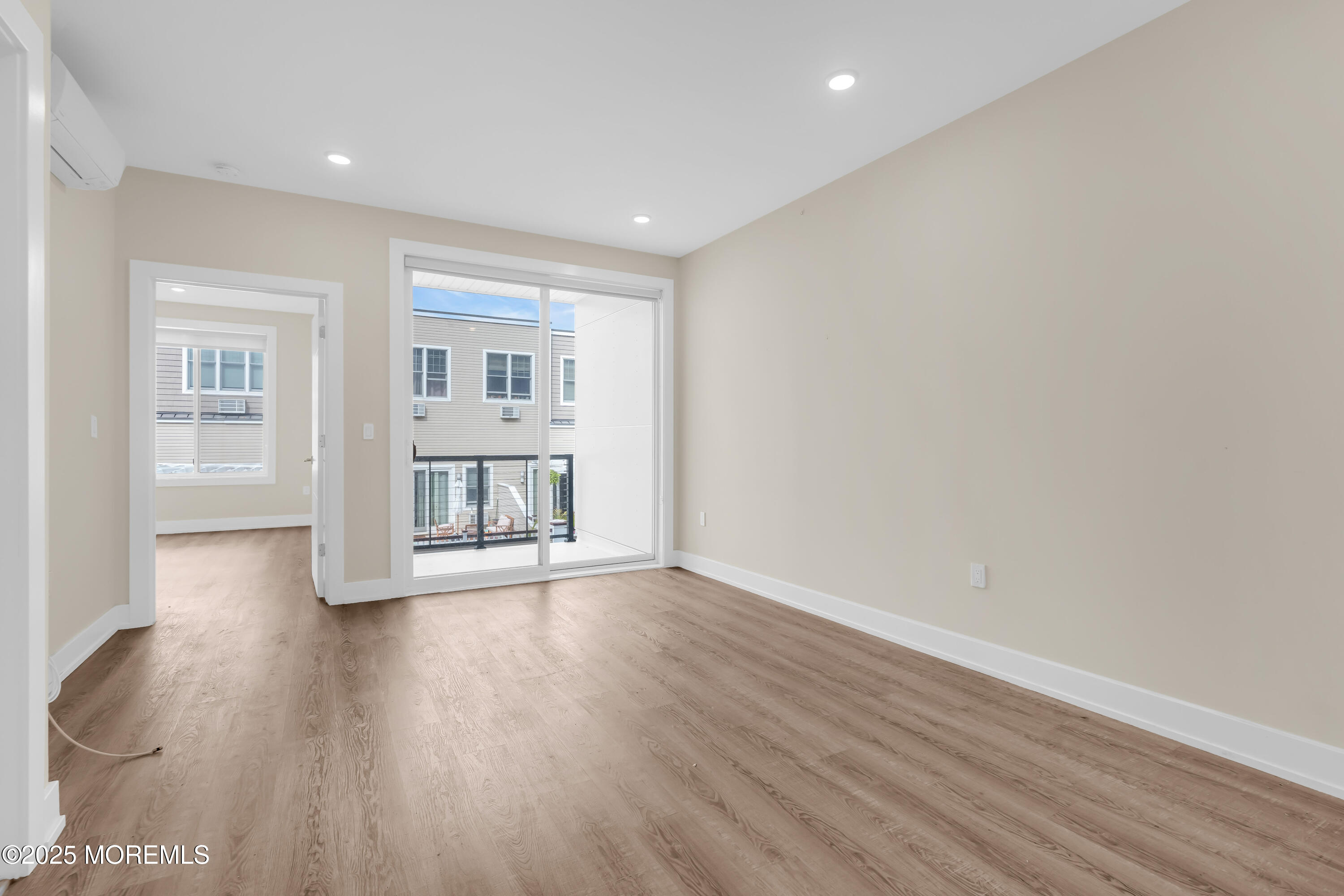 521 Lake Avenue, Unit 408 Asbury Park, NJ 07712 - Photo 17 of 30 a view of an empty room with a window and wooden floor