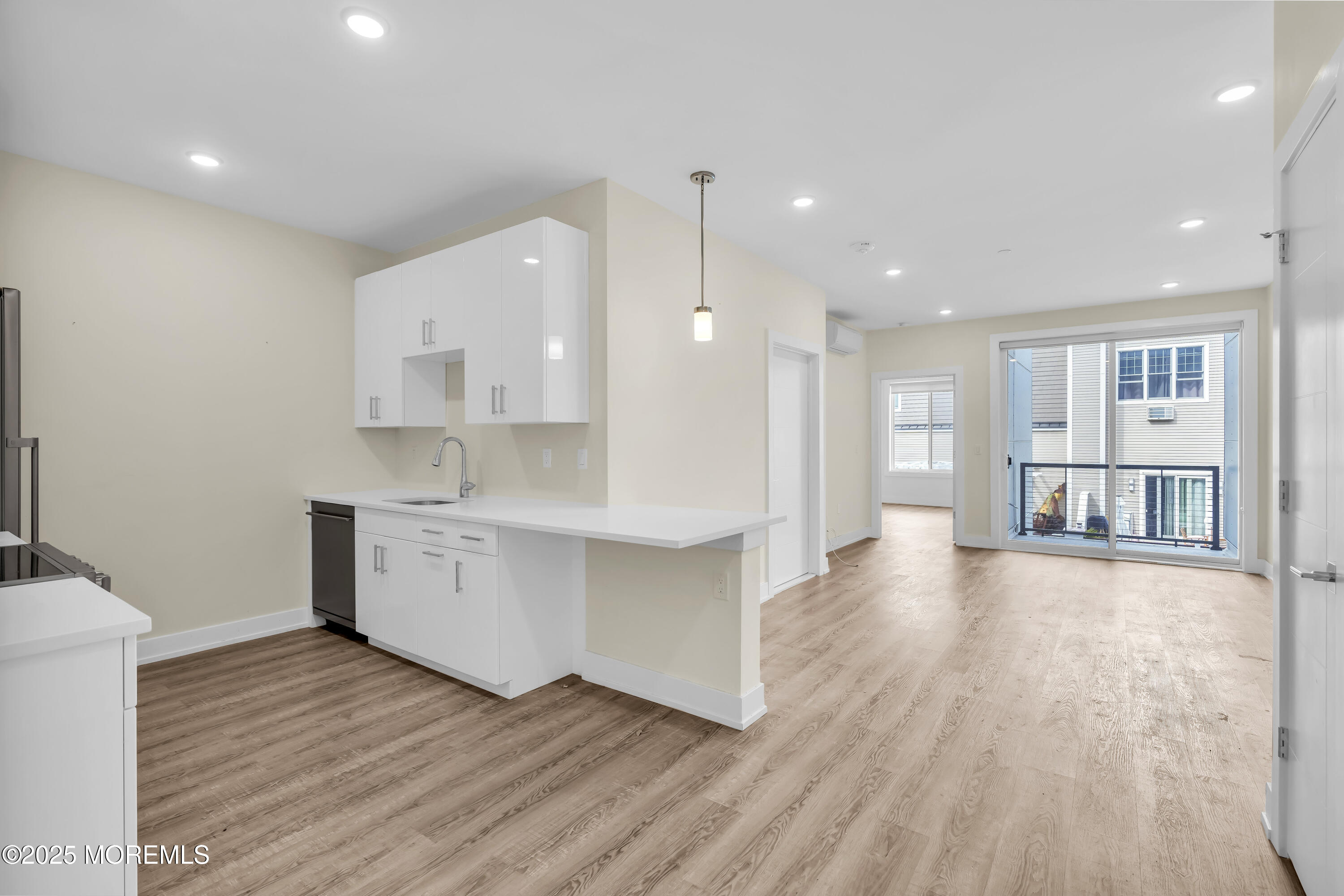 521 Lake Avenue, Unit 408 Asbury Park, NJ 07712 - Photo 10 of 30 a large kitchen with a wooden floor and a sink