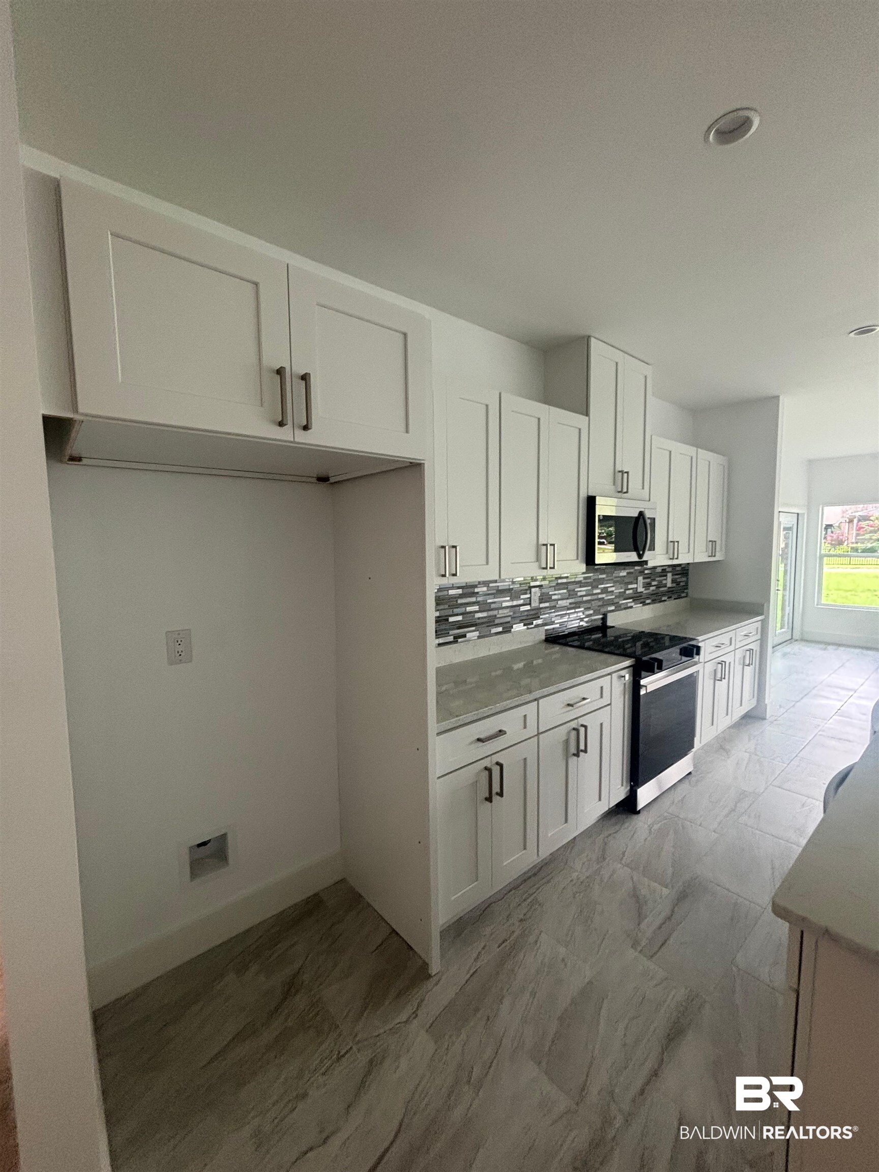23348 Dundee Circle Foley, AL 36535 - Photo 13 of 21 Kitchen featuring stainless steel appliances, backsplash, white cabinets, light countertops, and recessed lighting