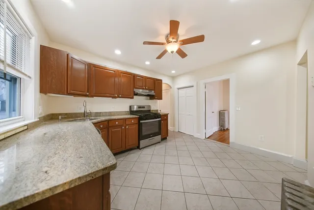 a kitchen with a stove a sink and a refrigerator