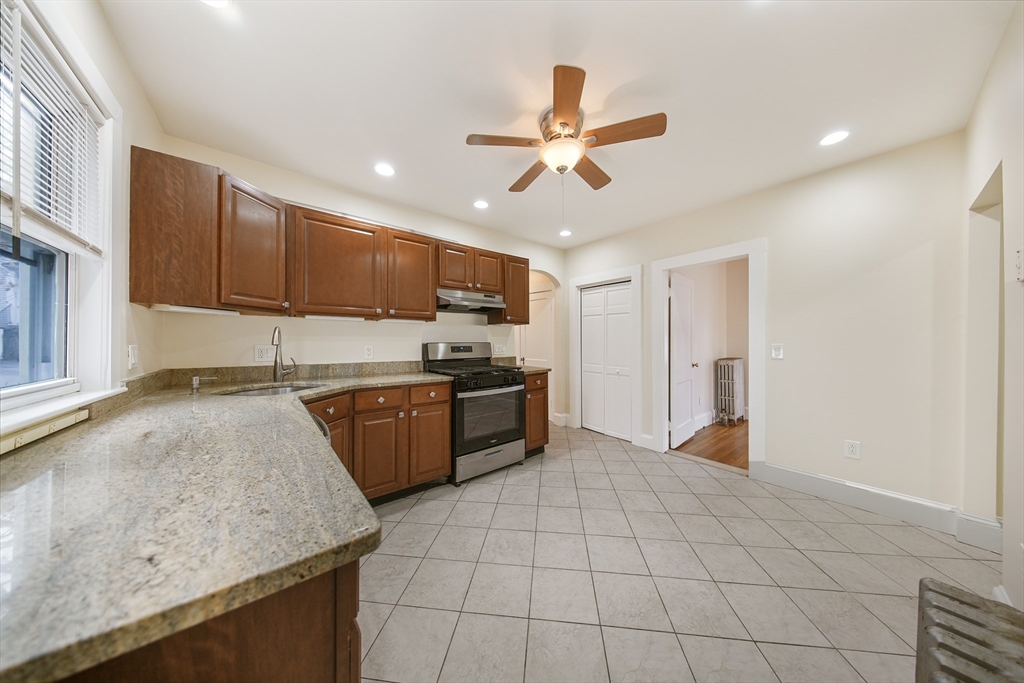 a kitchen with a stove a sink and a refrigerator