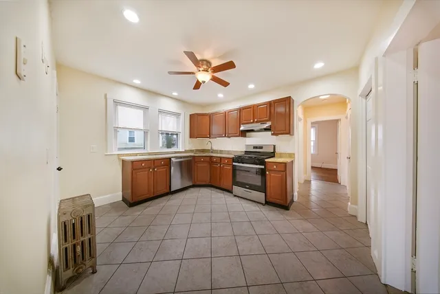 a kitchen with a sink a counter top space cabinets and stainless steel appliances