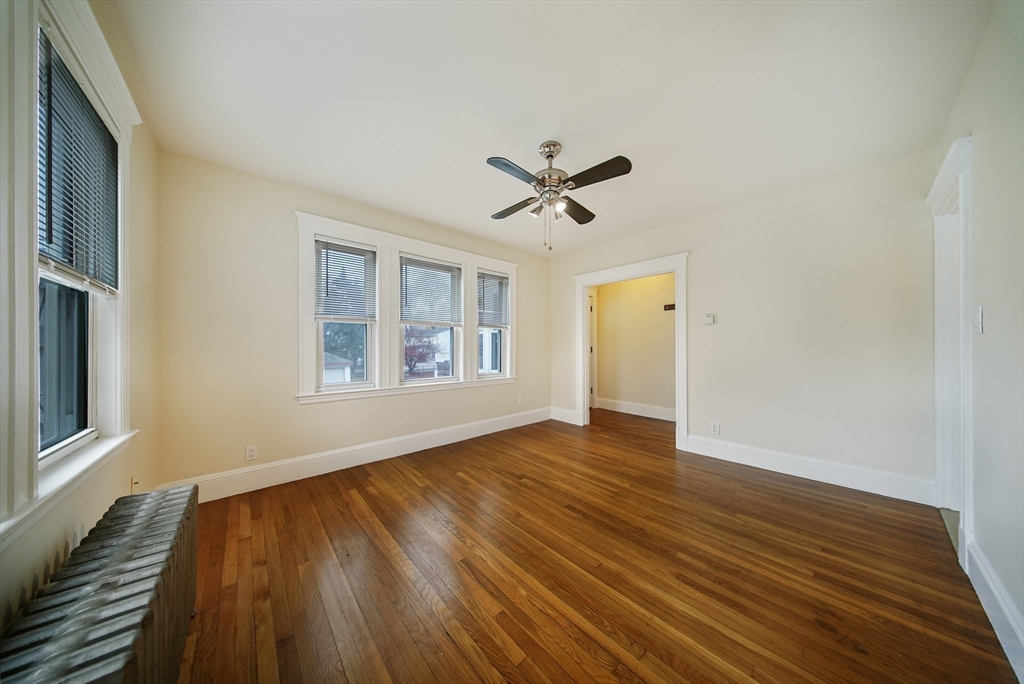 39 McDonald Street, Unit 39 Quincy, MA 02169 - Photo 6 of 15 a view of empty room with wooden floor and fan