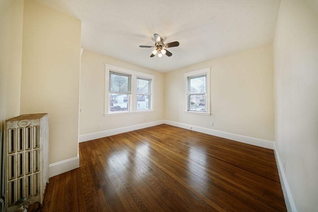 39 McDonald Street, Unit 39 Quincy, MA 02169 - Photo 9 of 15 a view of empty room with wooden floor and fan