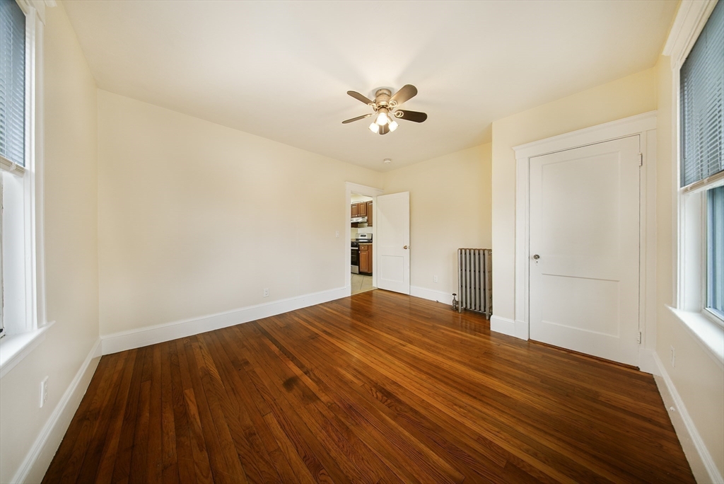 39 McDonald Street, Unit 39 Quincy, MA 02169 - Photo 10 of 15 a view of empty room with wooden floor and fan
