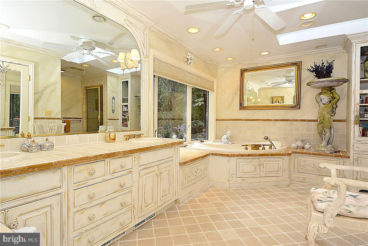 738 Intrepid Way Davidsonville, MD 21035 - Photo 34 of 71 a spacious bathroom with a granite countertop sink and a large mirror