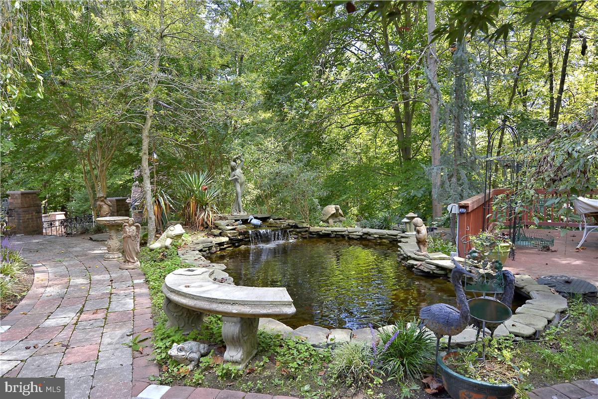 738 Intrepid Way Davidsonville, MD 21035 - Photo 48 of 71 a view of a backyard with table and chairs potted plants and large tree