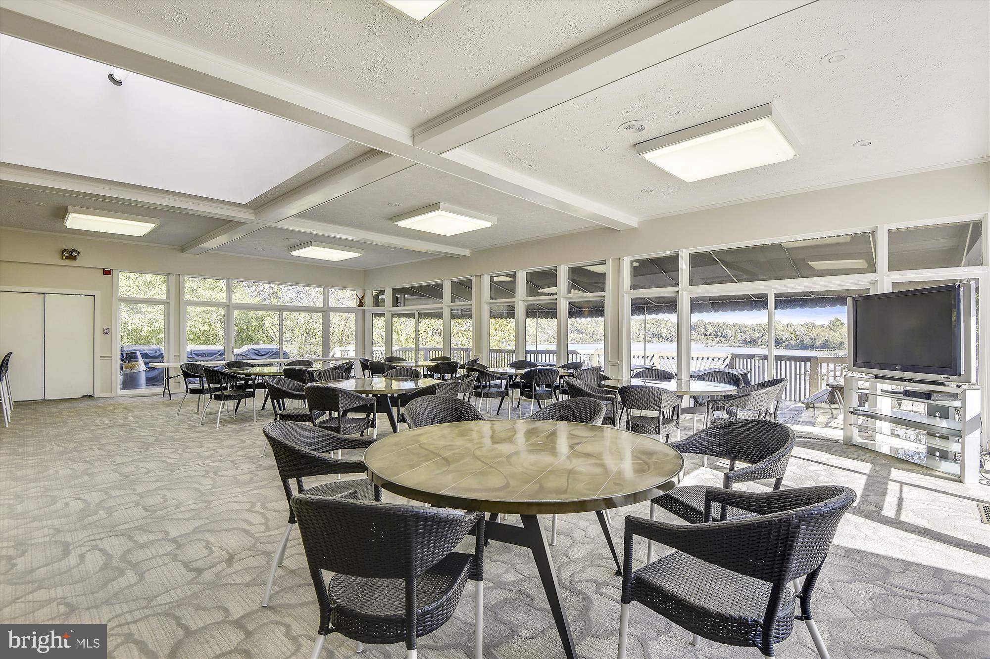 738 Intrepid Way Davidsonville, MD 21035 - Photo 58 of 71 a view of a dining room with furniture and a flat screen tv