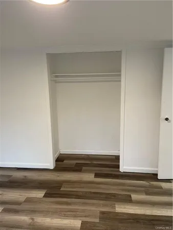 a view of a room that has a large window and a bed