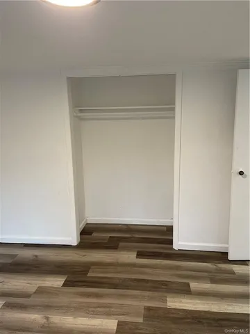 a view of a room that has a large window and a bed