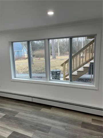 a view of an empty room and wooden floor