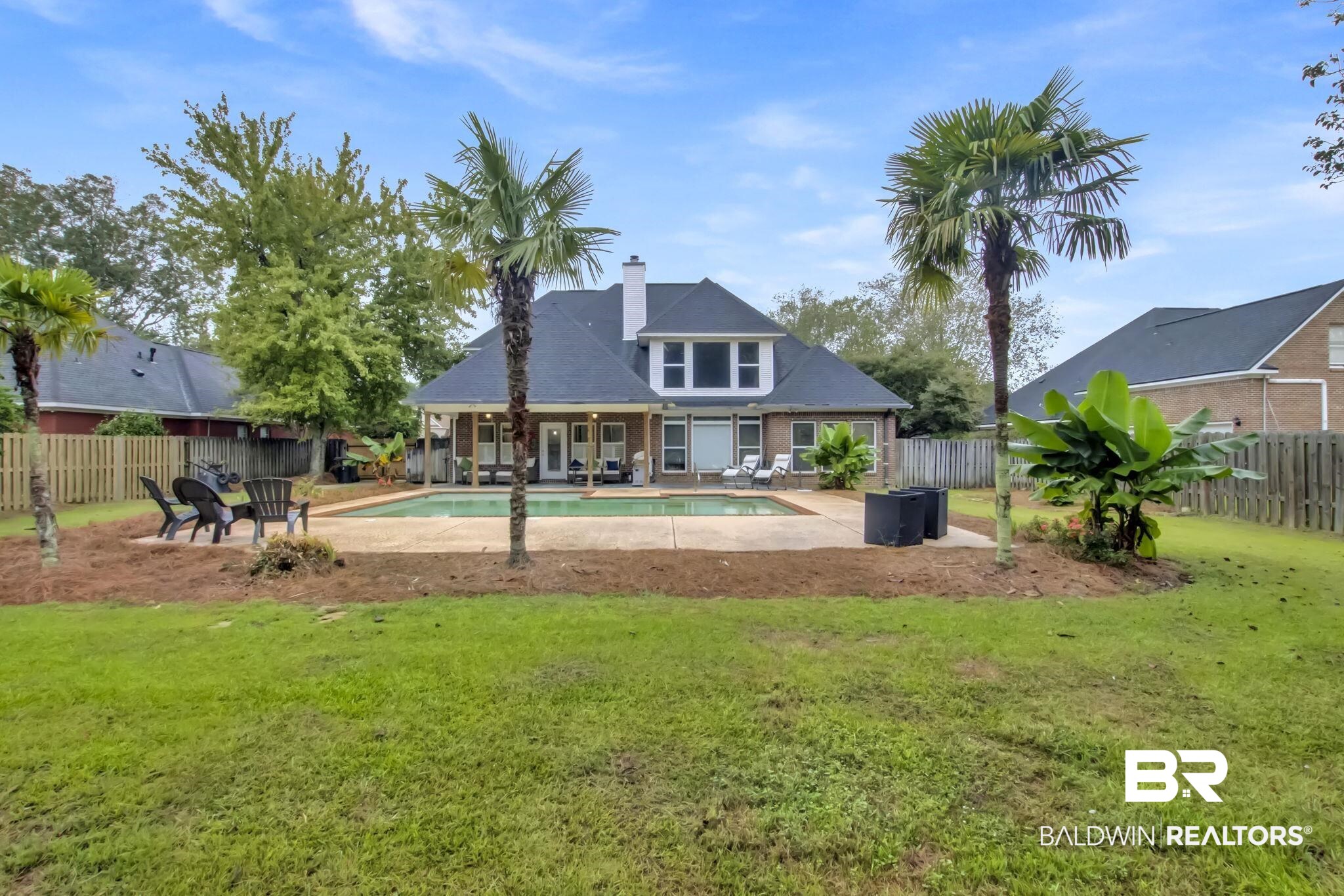 9002 Parliament Circle Daphne, AL 36526 - Photo 59 of 73 Back of property with a lawn, a fenced in pool, and a patio