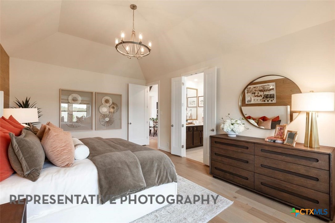 12213 Moon Pool Schertz, TX 78154 - Photo 11 of 32 a spacious bedroom with a bed and a dresser