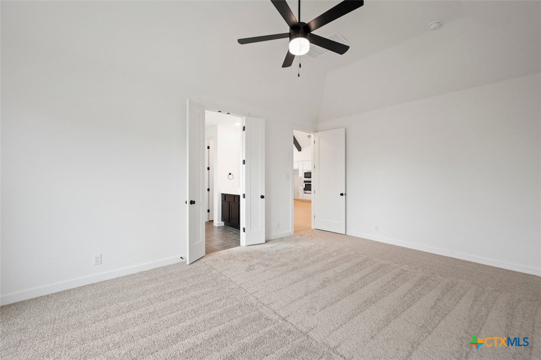 12213 Moon Pool Schertz, TX 78154 - Photo 11 of 25 a view of a room with a ceiling fan and refrigerator