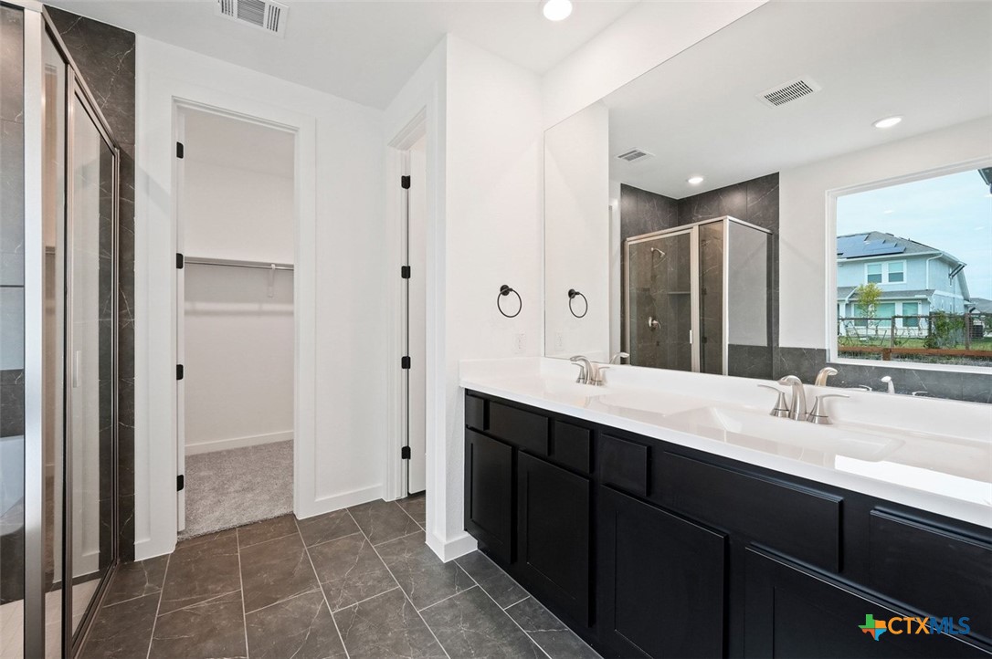 12213 Moon Pool Schertz, TX 78154 - Photo 12 of 25 a spacious bathroom with a double vanity sink mirror and double