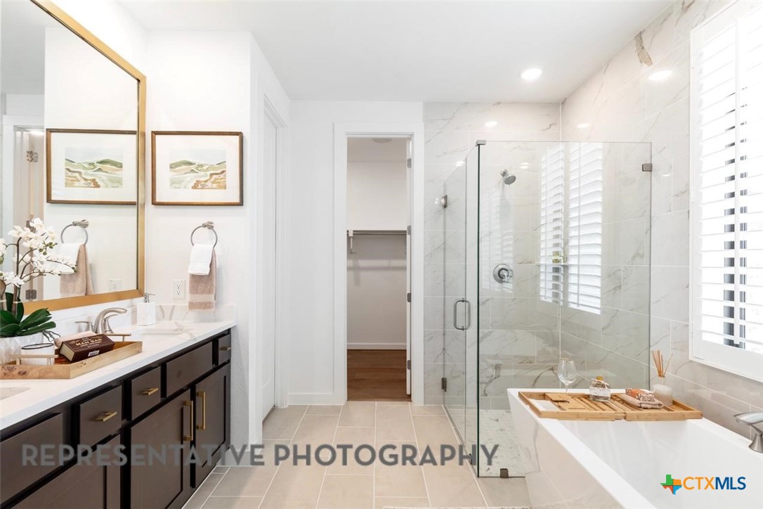 12213 Moon Pool Schertz, TX 78154 - Photo 12 of 32 a spacious bathroom with a tub sink and mirror