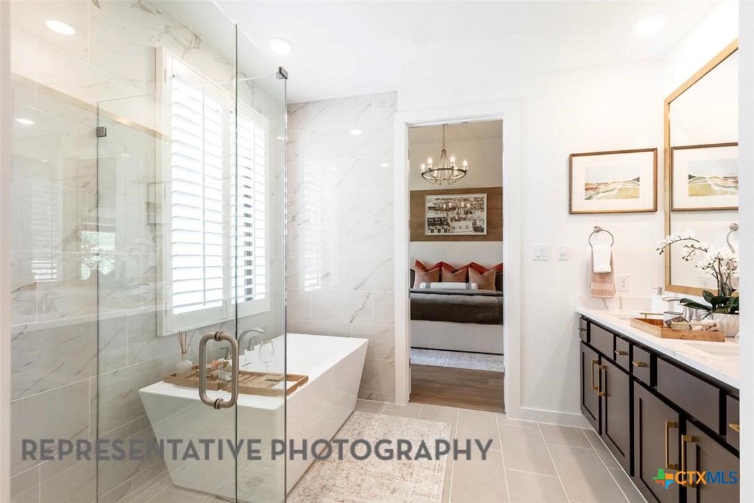 12213 Moon Pool Schertz, TX 78154 - Photo 15 of 32 a spacious bathroom with a tub sink and mirror