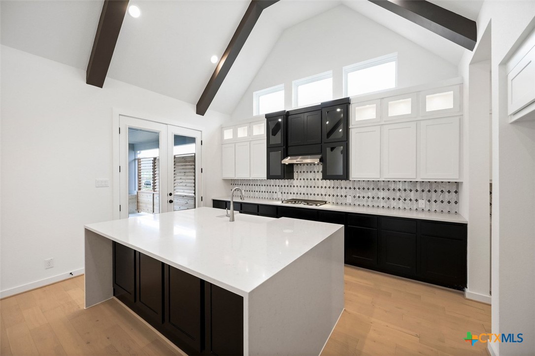12213 Moon Pool Schertz, TX 78154 - Photo 2 of 25 a kitchen with a sink and a stove top oven with wooden floor