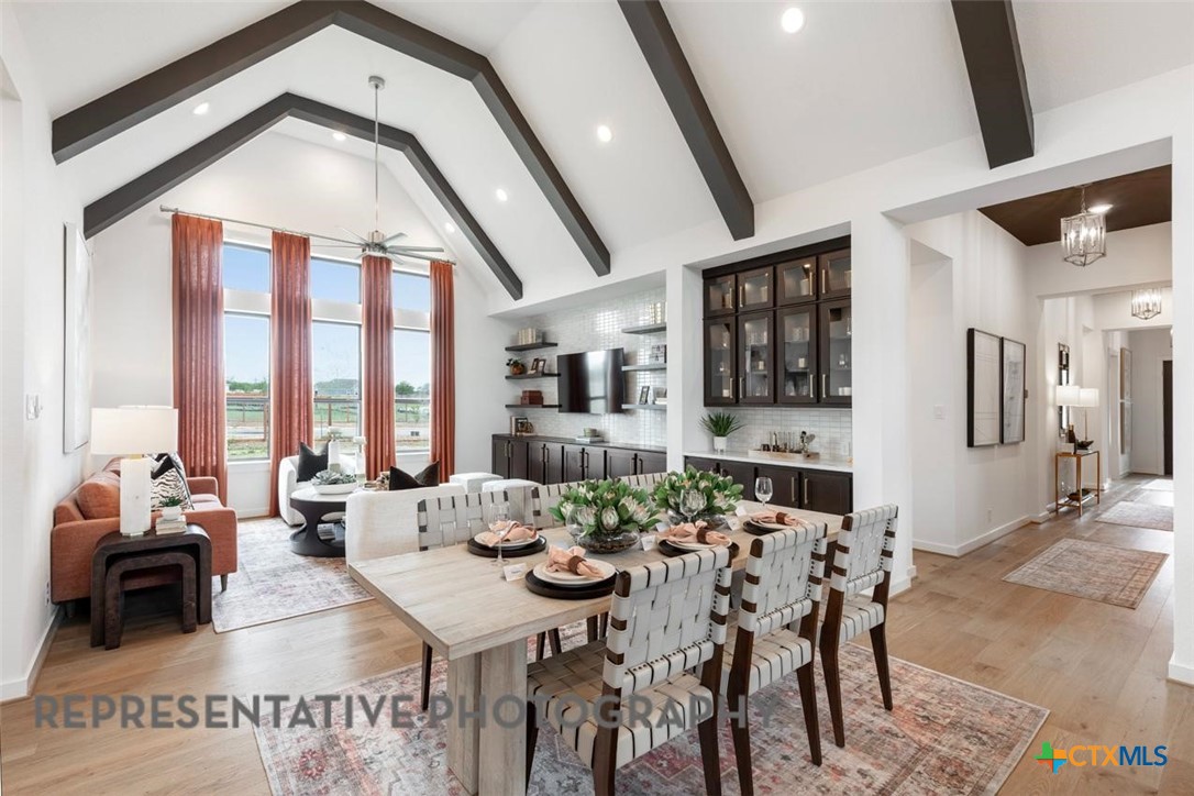 12213 Moon Pool Schertz, TX 78154 - Photo 22 of 32 a view of a dining room with furniture window and wooden floor
