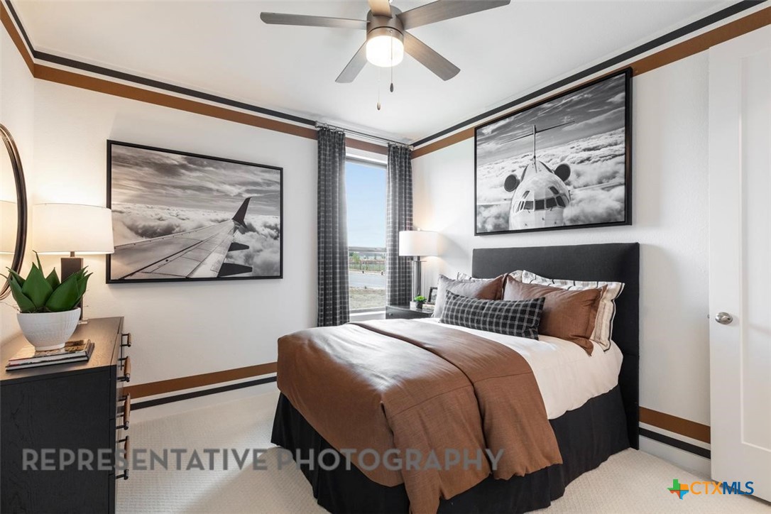 12213 Moon Pool Schertz, TX 78154 - Photo 24 of 32 a bedroom with a bed and a painting on the wall
